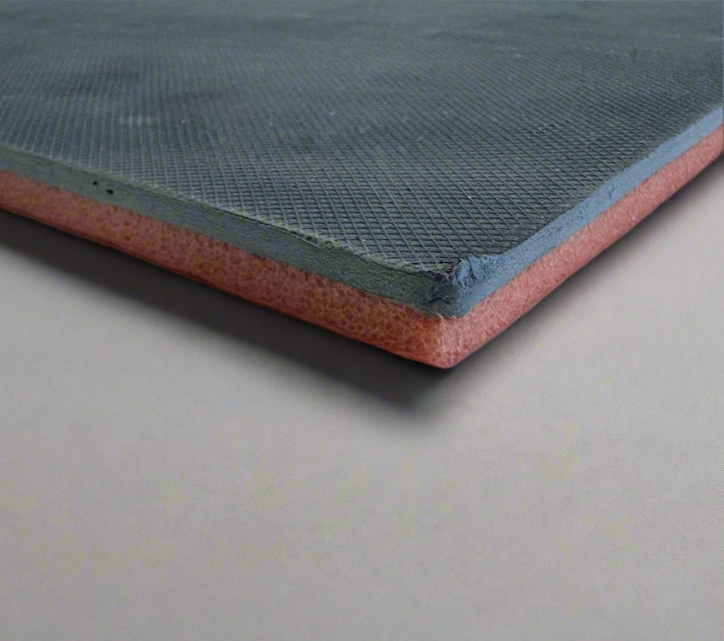 Close-up of a layered material with orange and blue, on a light gray background.