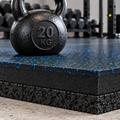 Black rubber gym flooring mat with blue speckles, shown in a gym setting with a 20 kg kettlebell on top.