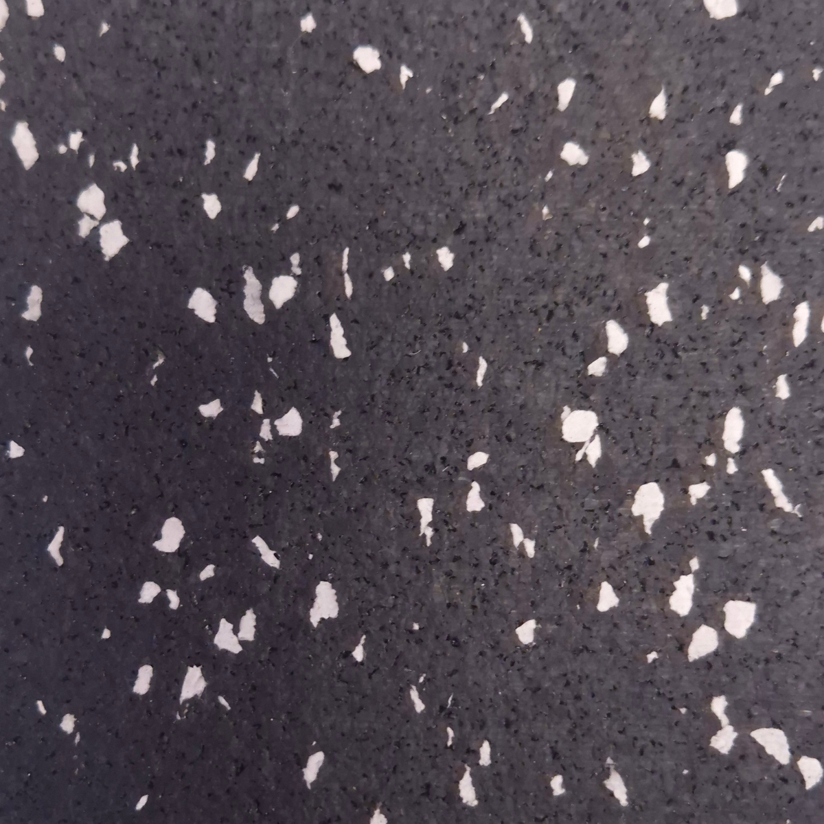 Close-up of a dark surface with white speckles