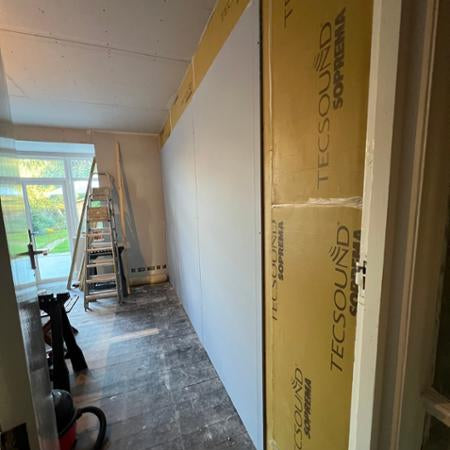 Room under construction with Knauf dB Board with TECSOUND acoustic membrane on a stud wall 