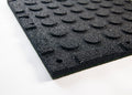 Close up shot of reverse side to TerraFit Duo gym tile, showing circular impac dispesion points and connection points to insert connecting clips shown along the perimeter