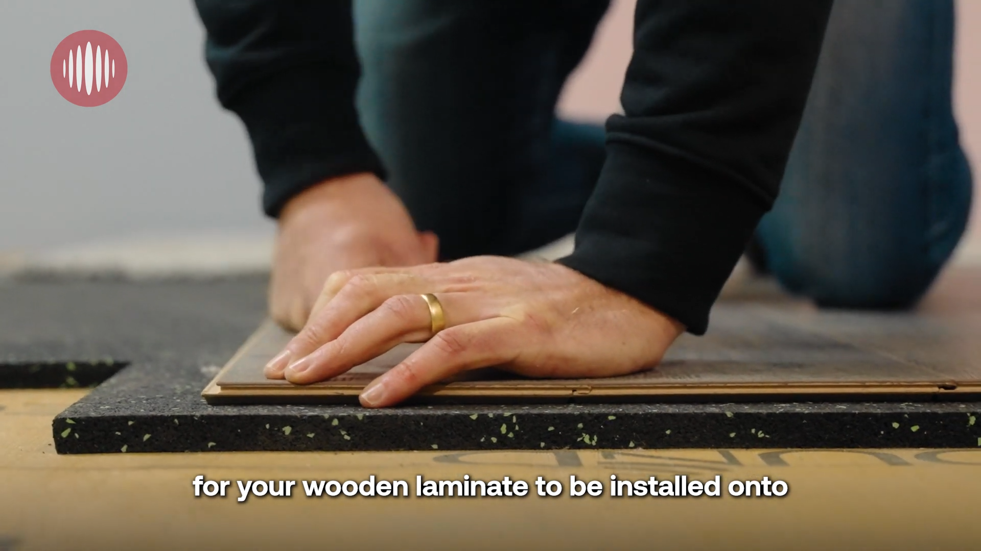 Installer laying laminate flooring directly over dB Matting