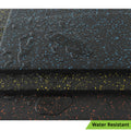 Alternate angle of Close-up of TerraFit Duo gym tile with water beading, showing water-resistant properties.