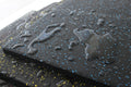 Close-up of TerraFit Duo gym tile with water beading, showing water-resistant properties.
