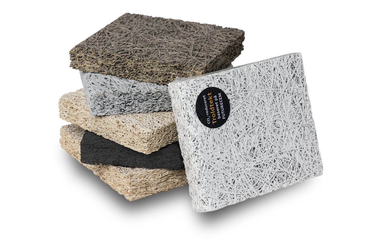 A stack of Toldtekt square samples in multiple earthy tones